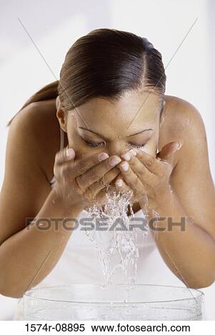 Young woman washing her face View Large Photo Image Stock Photography - Young woman washing her face. Fotosearch
