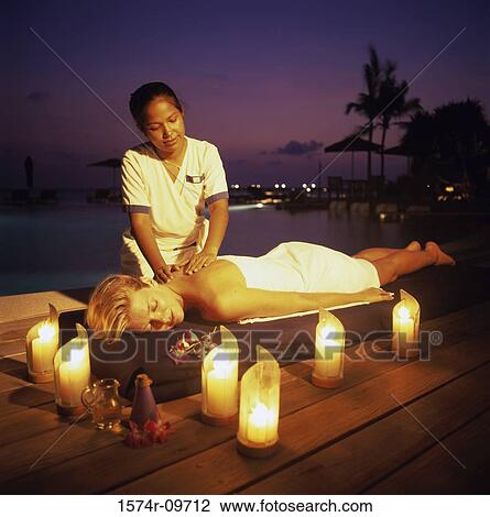 Young women lying down getting a back massage View Large Photo Image Stock Image - Young women lying down getting a back massage. Fotosearch