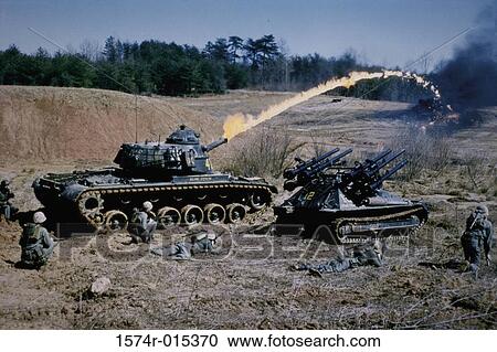 Stock Image - Army soldiers with military tanks on a battlefield. Fotosearch