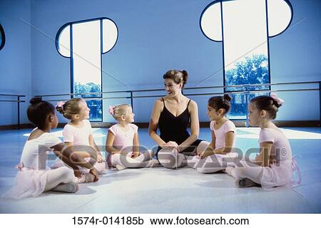 Ballet teacher talking to a group of girls View Large Photo Image Stock Image - Ballet teacher talking to a group of girls. Fotosearch