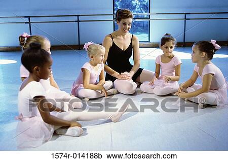 Ballet teacher talking to a group of girls View Large Photo Image Stock Image - Ballet teacher talking to a group of girls. Fotosearch