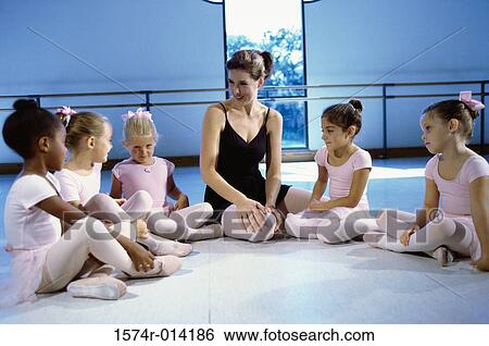Ballet teacher talking to a group of girls View Large Photo Image Stock Photograph - Ballet teacher talking to a group of girls. Fotosearch