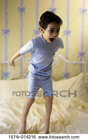 Boy jumping on a bed View Large Photo Image Stock Photograph - Boy jumping on a bed. Fotosearch
