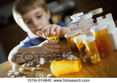 Boy opening a pill bottle View Large Photo Image Stock Image - Boy opening a pill bottle. Fotosearch