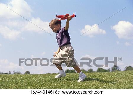 Boy playing with a model airplane View Large Photo Image Stock Image - Boy playing with a model airplane. Fotosearch