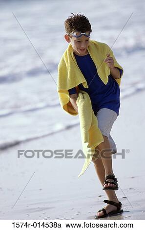 Boy stepping on the beach View Large Photo Image Stock Image - Boy stepping on the beach. Fotosearch