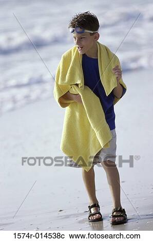 Boy walking on the beach View Large Photo Image Stock Image - Boy walking on the beach. Fotosearch