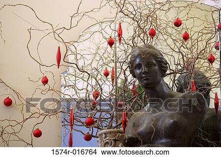 Christmas ornaments hanging on a bare tree View Large Photo Image Picture - Christmas ornaments hanging on a bare tree. Fotosearch