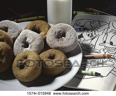 Close-up doughnuts on a plate over a coloring book View Large Photo Image Stock Photo - Close-up doughnuts on a plate over a coloring book. Fotosearch