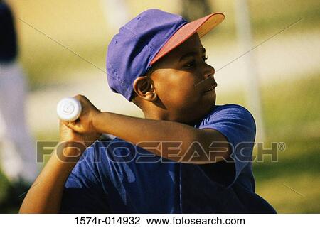 Stock Image - Close-up of a baseball player swinging a baseball bat. Fotosearch
