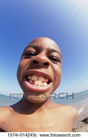 Close-up of a boy clenching his teeth on the beach View Large Photo Image Stock Image - Close-up of a boy clenching his teeth on the beach. Fotosearch