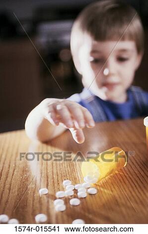 Close-up of a boy reaching out for pills View Large Photo Image Stock Image - Close-up of a boy reaching out for pills. Fotosearch