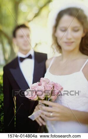 Close-up of a bride holding a bouquet of flowers View Large Photo Image Stock Image - Close-up of a bride holding a bouquet of flowers. Fotosearch