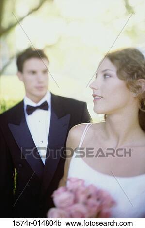 Close-up of a bride holding a bouquet of flowers View Large Photo Image Stock Image - Close-up of a bride holding a bouquet of flowers. Fotosearch
