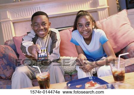 Close-up of a brother and sister watching television View Large Photo Image Stock Image - Close-up of a brother and sister watching television. Fotosearch