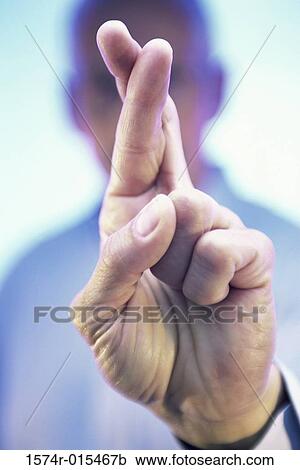 Close-up of a businessman's fingers crossed View Large Photo Image Stock Image - Close-up of a businessman's fingers crossed. Fotosearch