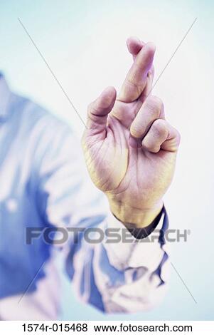 Close-up of a businessman's fingers crossed View Large Photo Image Stock Photo - Close-up of a businessman's fingers crossed. Fotosearch