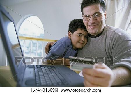 Close-up of a father and son sitting in front of a laptop View Large Photo Image Stock Image - Close-up of a father and son sitting in front of a laptop. Fotosearch
