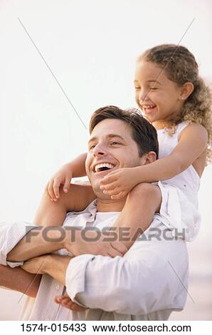 Close-up of a father carrying his daughter on his shoulders View Large Photo Image Stock Image - Close-up of a father carrying his daughter on his shoulders. Fotosearch