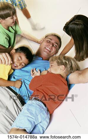 Close-up of a father sitting on a swing with his son View Large Photo Image Stock Image - Close-up of a father sitting on a swing with his son. Fotosearch