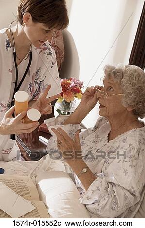 Close-up of a female nurse giving prescription to a patient View Large Photo Image Stock Image - Close-up of a female nurse giving prescription to a patient. Fotosearch