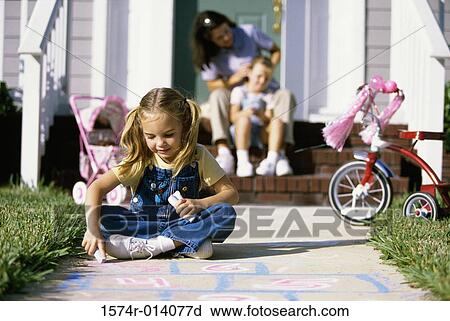 Close-up of a girl drawing hopscotch View Large Photo Image Stock Image - Close-up of a girl drawing hopscotch. Fotosearch