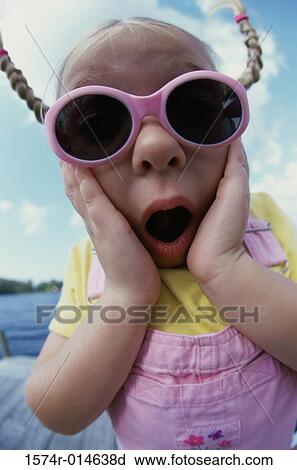 Stock Image - Close-up of a girl looking shocked. Fotosearch