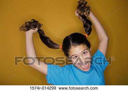 Close-up of a girl pulling her hair View Large Photo Image Stock Photo - Close-up of a girl pulling her hair. Fotosearch