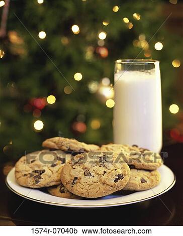 Stock Image - Close-up of a glass of milk and a plate of cookies. Fotosearch