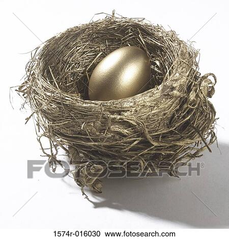 Stock Image - Close-up of a golden egg in a nest. Fotosearch