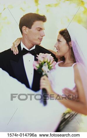 Close-up of a groom carrying his bride View Large Photo Image Stock Image - Close-up of a groom carrying his bride. Fotosearch