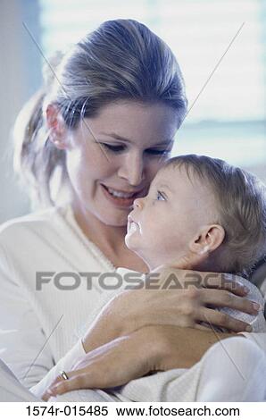 Close-up of a mother hugging her son View Large Photo Image Stock Photography - Close-up of a mother hugging her son. Fotosearch