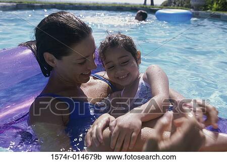 Close-up of a mother lying on a pool raft with her daughter View Large Photo Image Stock Image - Close-up of a mother lying on a pool raft with her daughter. Fotosearch
