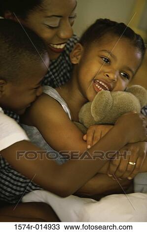 Stock Image - Close-up of a mother smiling with her two children. Fotosearch