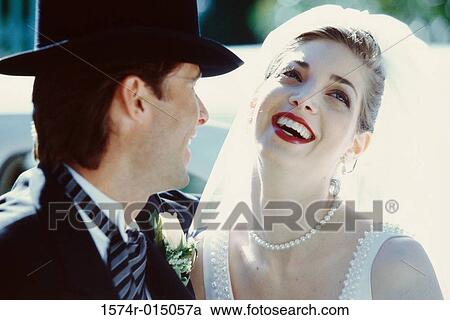 Close-up of a newlywed couple laughing View Large Photo Image Stock Image - Close-up of a newlywed couple laughing. Fotosearch