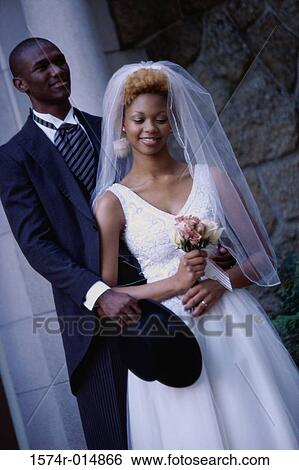 Close-up of a newlywed couple standing View Large Photo Image Stock Photograph - Close-up of a newlywed couple standing. Fotosearch