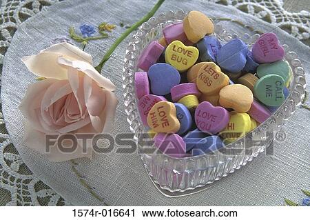 Close-up of a rose and candies in a bowl View Large Photo Image Stock Image - Close-up of a rose and candies in a bowl. Fotosearch