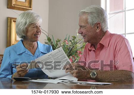 Stock Image - Close-up of a senior couple looking at each other smiling. Fotosearch
