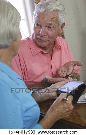 Close-up of a senior couple talking to each other View Large Photo Image Stock Image - Close-up of a senior couple talking to each other. Fotosearch