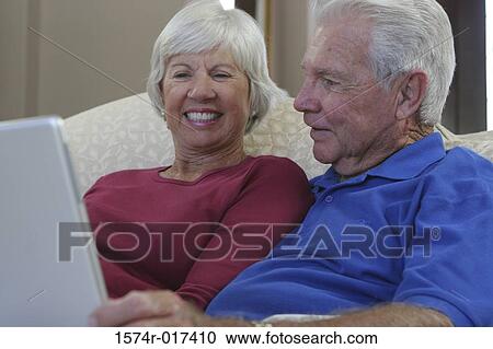 Stock Image - Close-up of a senior couple using a laptop. Fotosearch
