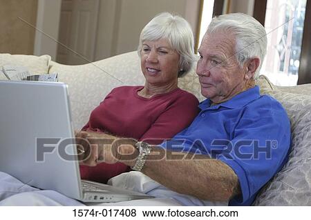 Close-up of a senior couple using a laptop View Large Photo Image Stock Photo - Close-up of a senior couple using a laptop. Fotosearch