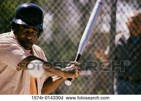 Stock Image - Close-up of a senior man playing baseball. Fotosearch