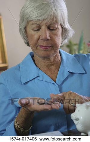 Close-up of a senior woman counting coins View Large Photo Image Stock Photograph - Close-up of a senior woman counting coins. Fotosearch