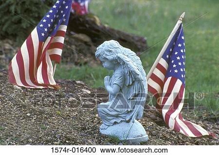 Close-up of a statue and an American flag View Large Photo Image Stock Image - Close-up of a statue and an American flag. Fotosearch