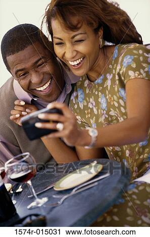Close-up of a young couple taking a photograph of themselves View Large Photo Image Stock Image - Close-up of a young couple taking a photograph of themselves. Fotosearch