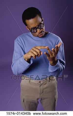 Close-up of a young man counting on his fingers View Large Photo Image Stock Image - Close-up of a young man counting on his fingers. Fotosearch
