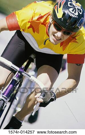 Close-up of a young man cycling View Large Photo Image Stock Photo - Close-up of a young man cycling. Fotosearch
