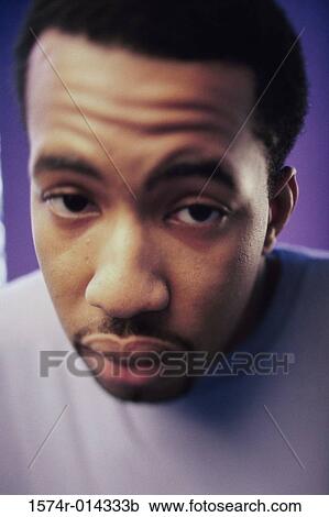 Stock Image - Close-up of a young man looking sad. Fotosearch