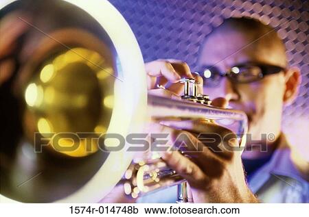 Close-up of a young man playing the trumpet View Large Photo Image Stock Image - Close-up of a young man playing the trumpet. Fotosearch