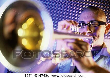 Close-up of a young man playing the trumpet View Large Photo Image Stock Image - Close-up of a young man playing the trumpet. Fotosearch